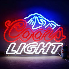 Neon Coors Light sign with mountain graphic on a dark background