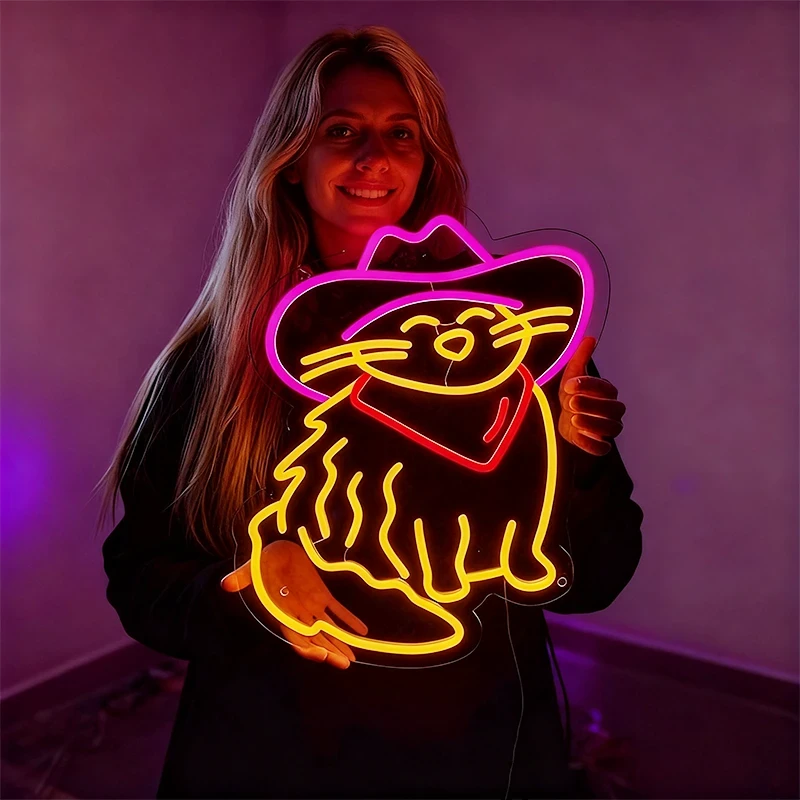 Woman holding a neon sign of a cat in a cowboy hat against a purple background