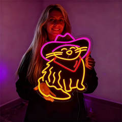Woman holding a neon sign of a cat in a cowboy hat against a purple background