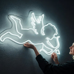 Neon white light of a cupid on a dark background