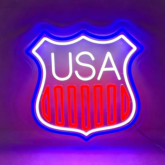 Neon sign with 'USA' text inside a shield shape on a dark background
