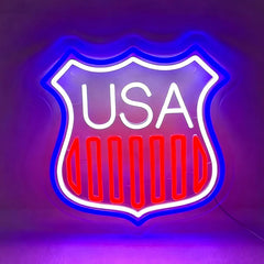Neon sign with 'USA' text inside a shield shape on a dark background