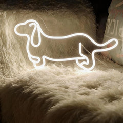 Neon wite light shaped like a dachshund on a fluffy surface