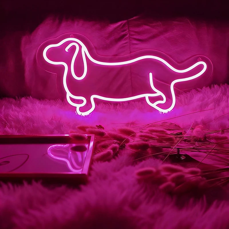 Neon light shaped like a dachshund on a soft surface with hot pink lighting