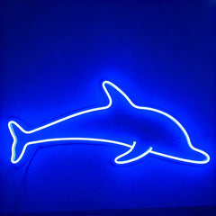 Neon dolphin shape on a blue background