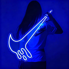 Person holding a blue neon nike-shaped light against a blue background