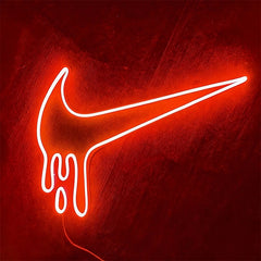 neon dripping nike logo red light on a wooden background