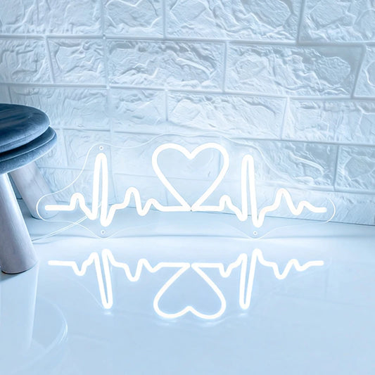 White neon sign shaped like a heart with heartbeat lines on a textured wall.