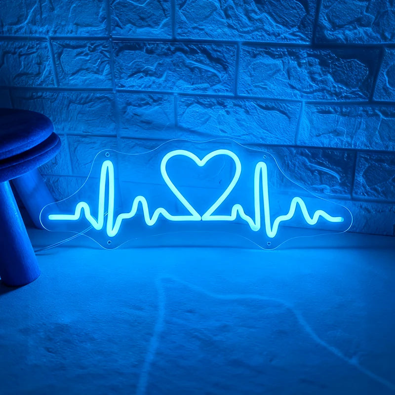 Neon with blue light shaped like a heart with an ECG line on a textured wall.