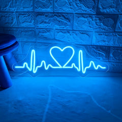 Neon with blue light shaped like a heart with an ECG line on a textured wall.