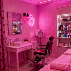 Salon interior with sink, chair, hot pink elegant nude lady neon sign, and shelves.