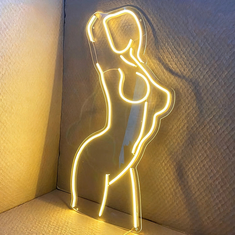 Neon lemon yellow  light shaped like an elegant nude lady  on a dark background