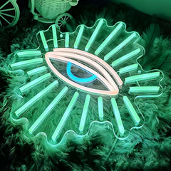 Neon eye-shaped light fixture on a textured surface