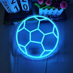 Neon light shaped like a soccer ball on a dark background