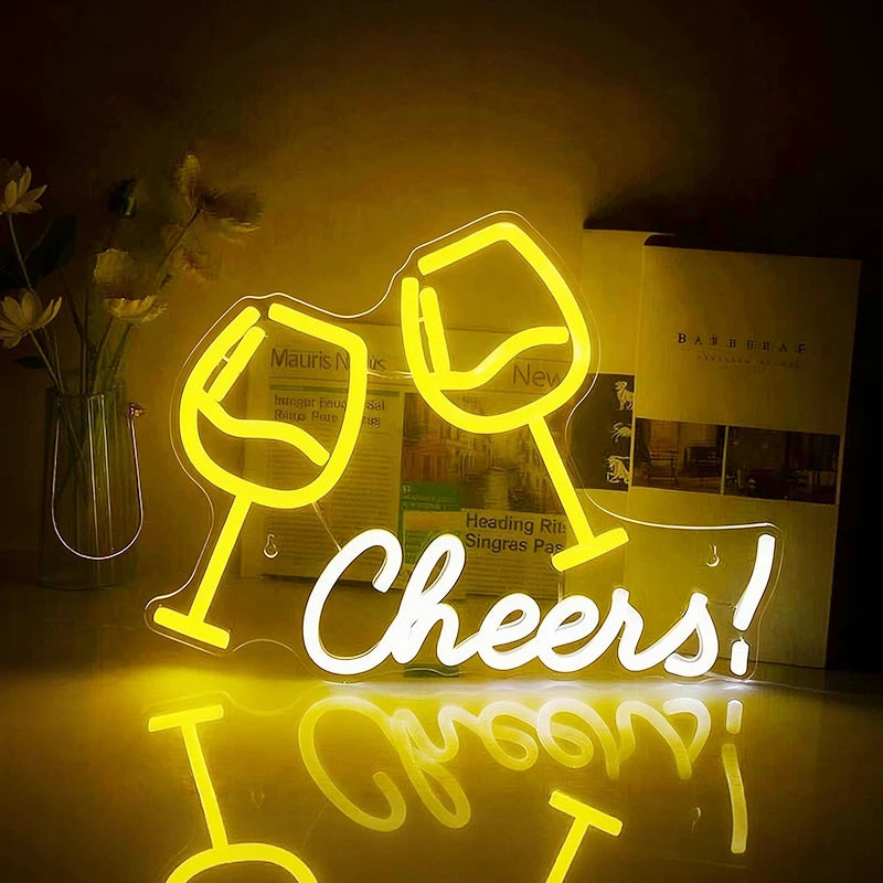 Neon sign with two wine glasses and the word 'Cheers!' in a store setting.