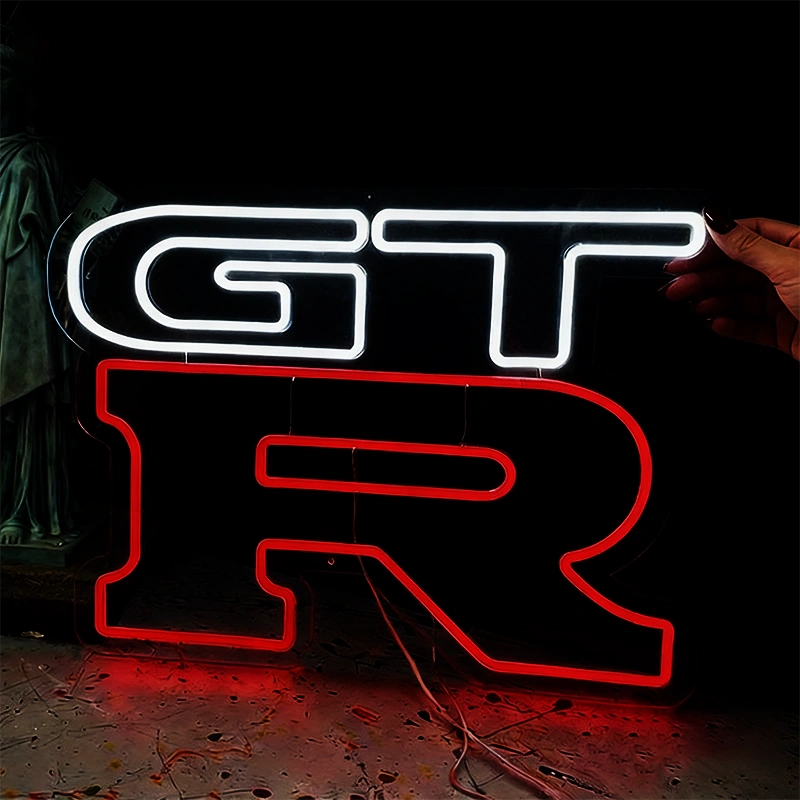Neon sign with 'GT R' on a dark background