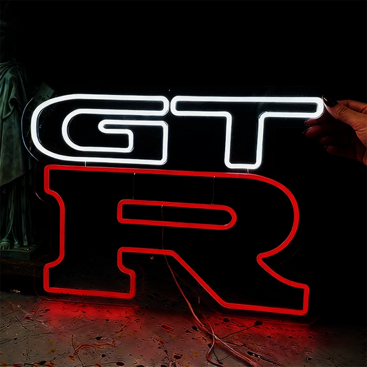 Neon sign with 'GT R' on a dark background