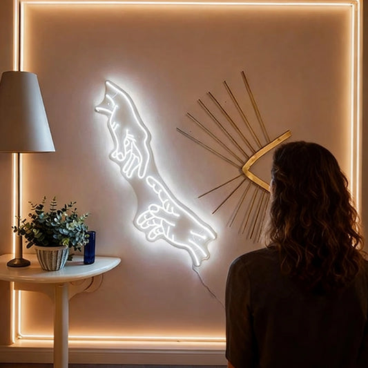 Hands of god neon white light on a wall, with a person observing it. 