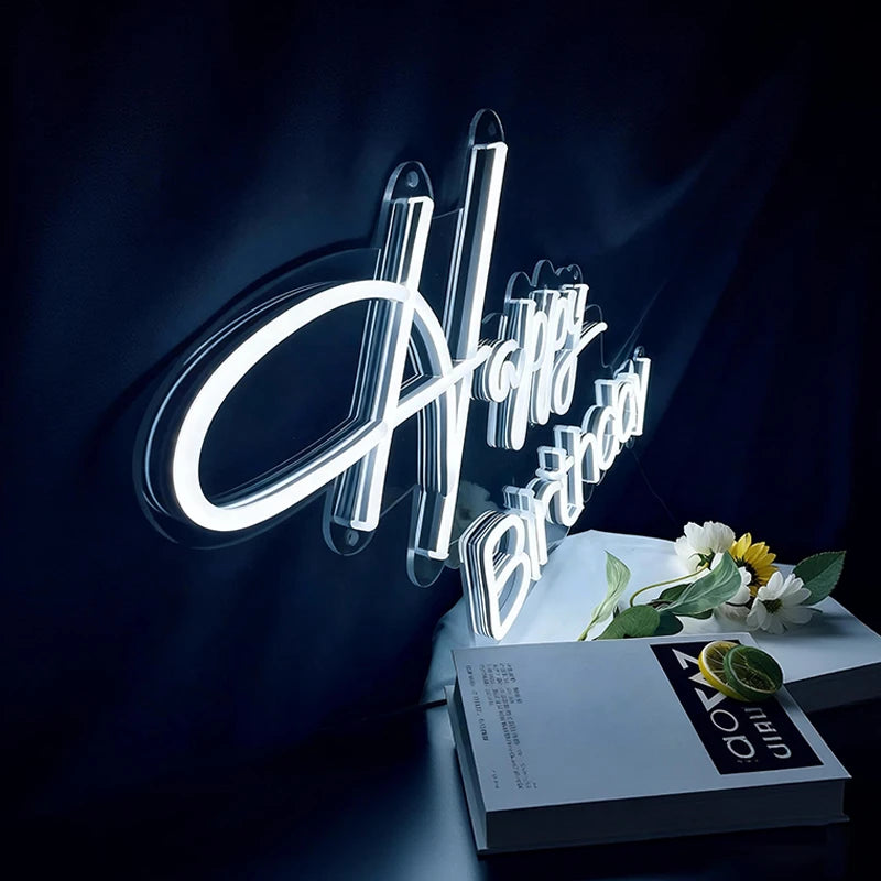 Neon sign with 'Happy Birthday' on a dark background