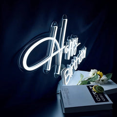 Neon sign with 'Happy Birthday' on a dark background