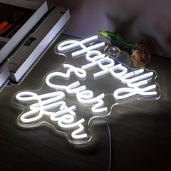 Neon sign with 'Happy Ever After' on a dark surface