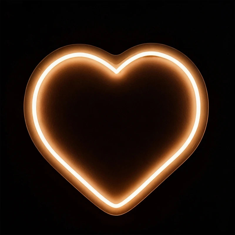 Neon heart shape light on a black background