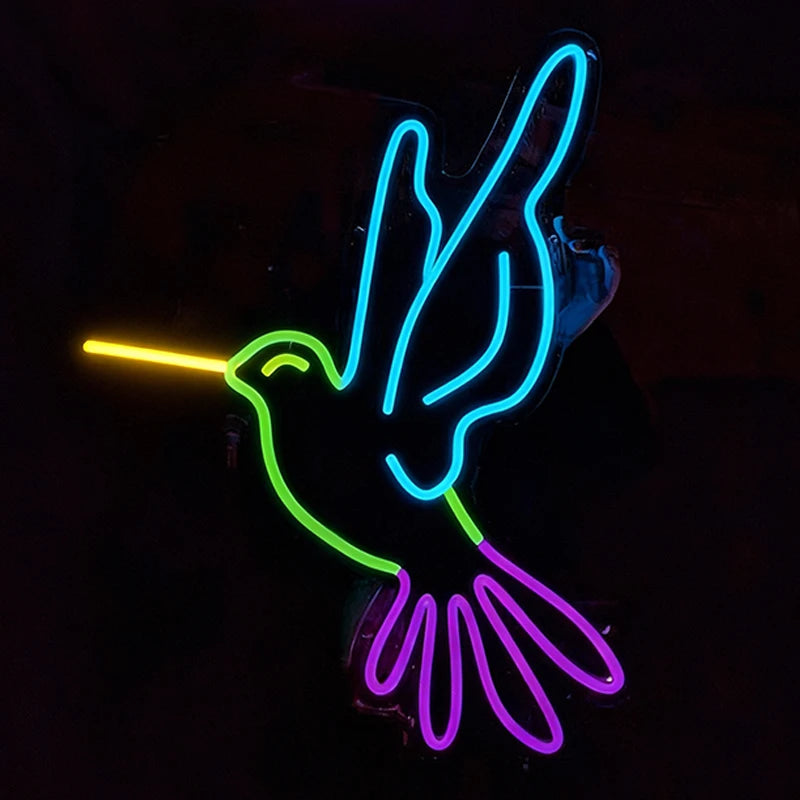 Neon sign of a humming bird with lemon yellow, green, ice blue, and purple colors on a black background