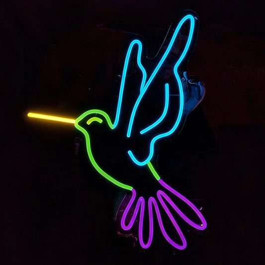 Neon sign of a humming bird with lemon yellow, green, ice blue, and purple colors on a black background