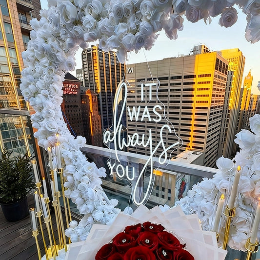 Decorative setup with 'it was always you' neon sign.