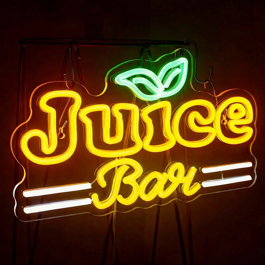 Neon sign with 'Juice Bar' text and leaf design on a dark background