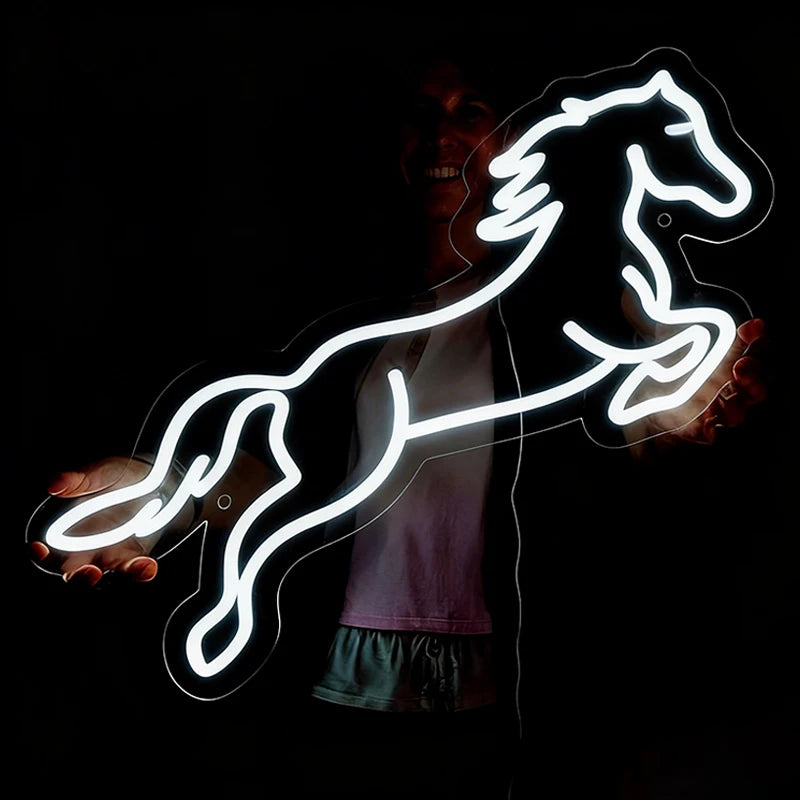 Neon white light shaped like a horse on a dark background