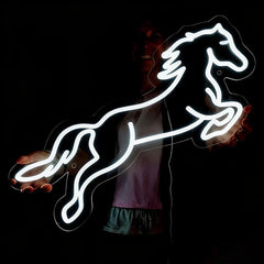 Neon white light shaped like a horse on a dark background
