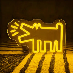 Yellow neon sign shaped like a barking dog on a dark background