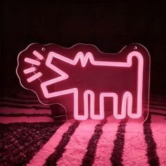 Light pink neon sign shaped like a barking dog on a dark background