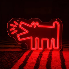Neon sign shaped like a red barking dog on a dark background