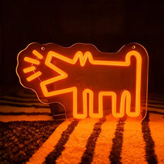 Orange neon sign shaped like a barking dog on a dark background