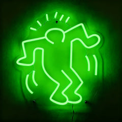 Neon green sign of a stylized figure on a dark background