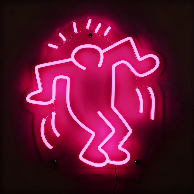 Neon pink sign of a stylized figure on a dark background