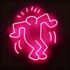Neon pink sign of a stylized figure on a dark background