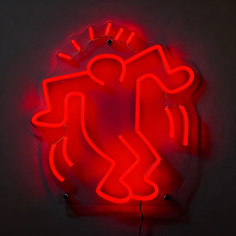Red neon sign of a stylized figure on a dark background