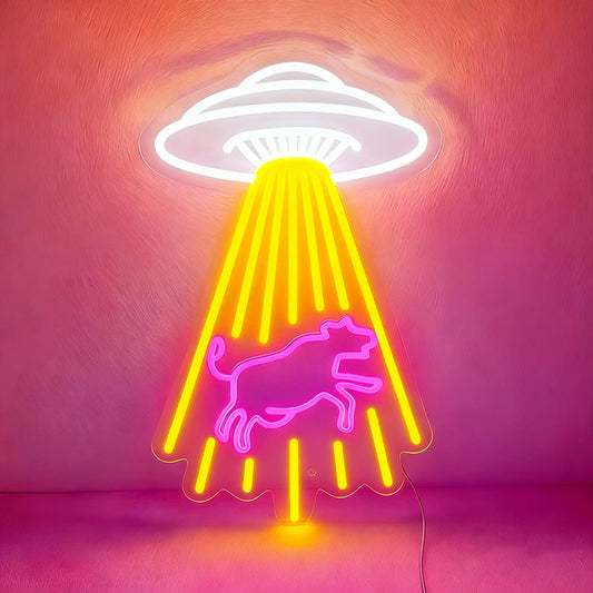 Neon sign with a white UFO and hot pink bull design on a pink background