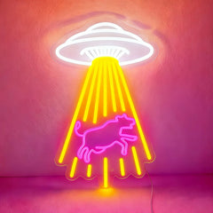Neon sign with a white UFO and hot pink bull design on a pink background