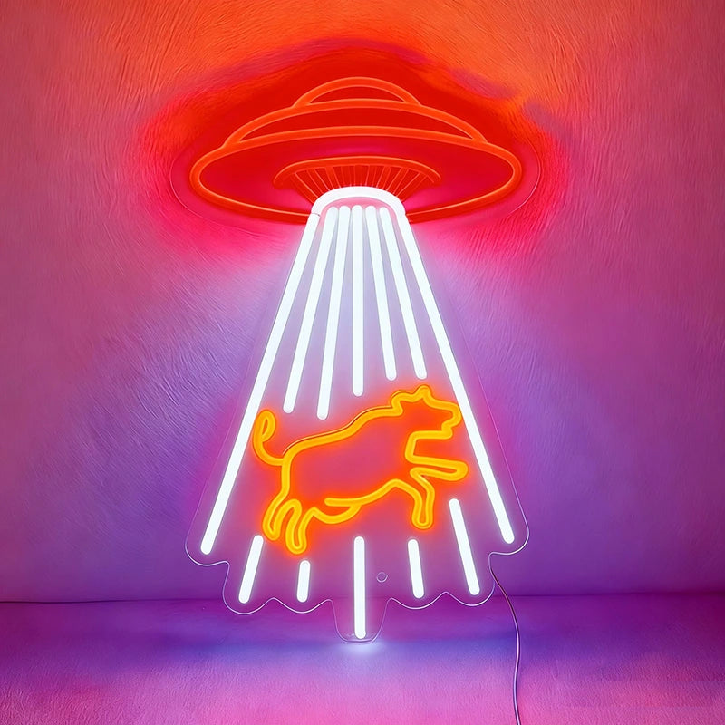 Neon sign with a red UFO and orange cow design on a pink background