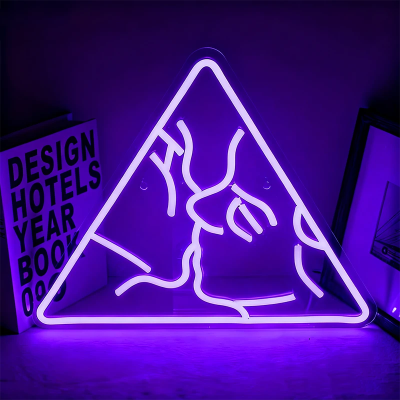 Neon purple sign of a couple kissing in a triangle on a dark background