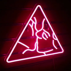 Neon hot pink sign of two people kissing in a triangle on a dark background