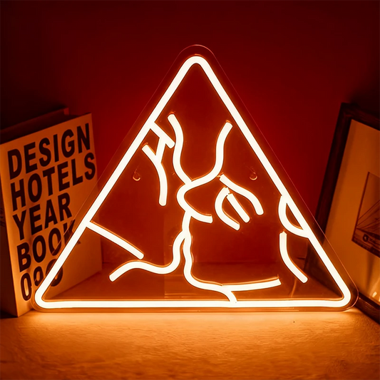 Neon warm white sign of a couple kissing in a triangle shape on a dark background