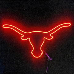 Neon sign of a bull head on a dark background
