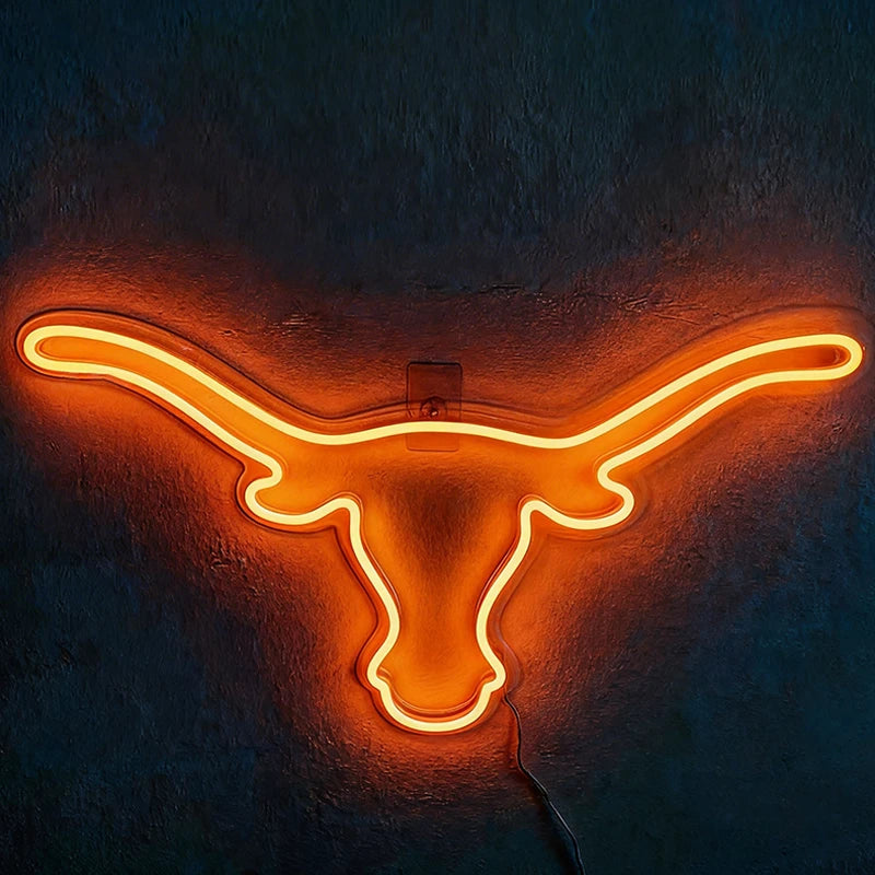 Neon sign shaped like a longhorn on a dark background