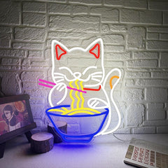Neon light shaped like a lucky cat eating noodles against a brick wall.