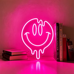 Neon light shaped like a smiley face with a hot pink background